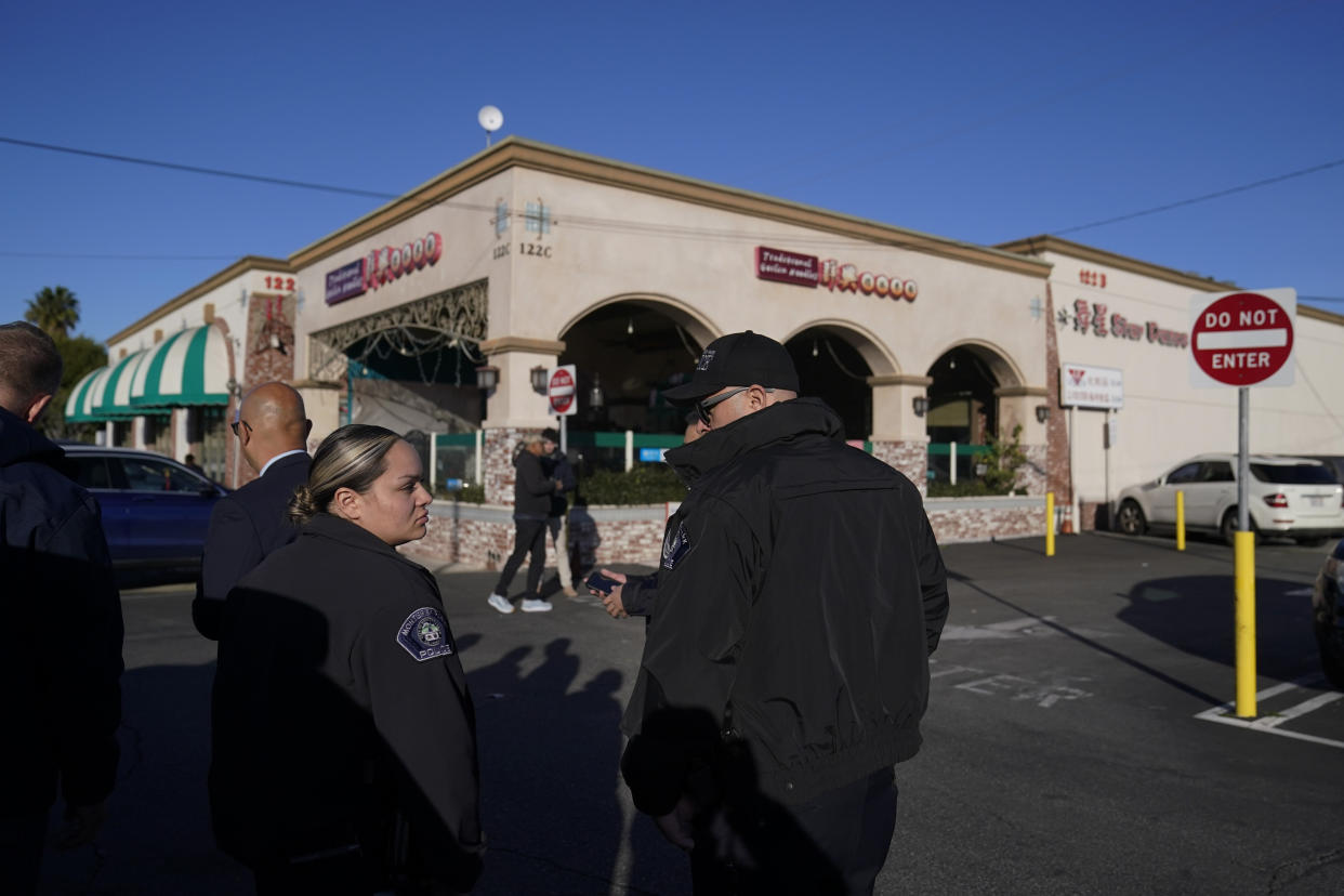 Monterey Park police officers stand outside Star Dance Studio in Monterey Park, Calif., Monday, Jan. 23, 2023. Authorities searched for a motive for the gunman who killed 10 people at the ballroom dance club during Lunar New Year celebrations. (AP Photo/Jae C. Hong)