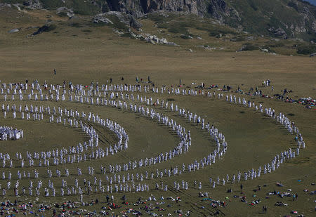 Followers of the Universal White Brotherhood, an esoteric society that combines Christianity and Indian mysticism set up by Bulgarian Peter Deunov in the 1920s, perform a dance-like ritual called "paneurhythmy" in Rila Mountain, Bulgaria, August 19, 2017. REUTERS/Stoyan Nenov