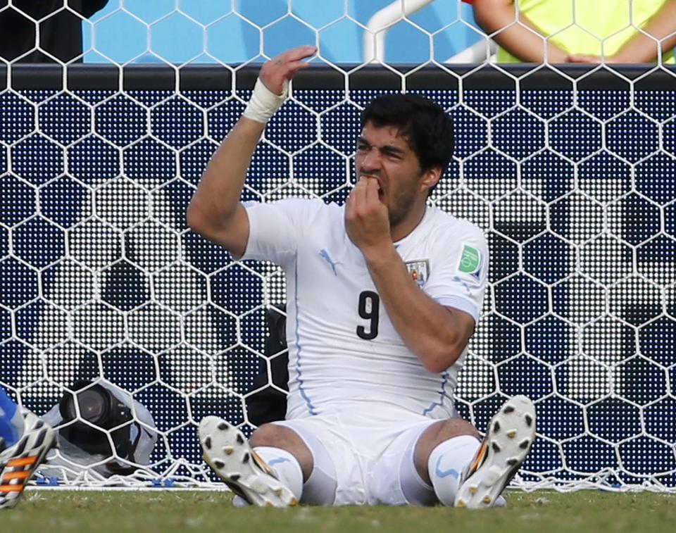 Uruguay's Luis Suarez holds his teeth during the 2014 World Cup Group D soccer match between Uruguay and Italy at the Dunas arena in Natal June 24, 2014. Italy's Giorgio Chiellini accused Suarez of biting his shoulder. REUTERS/Yves Herman (BRAZIL - Tags: TPX IMAGES OF THE DAY SOCCER SPORT WORLD CUP)