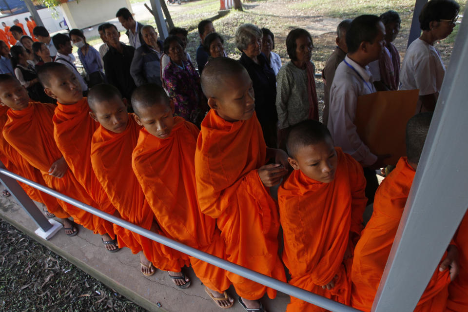 Cambodian Buddhist monks wait in queue to enter into the courtroom before the hearings against two former Khmer Rouge senior leaders, at the U.N.-backed war crimes tribunal on the outskirts of Phnom Penh, Cambodia, Friday, Nov. 16, 2018. The U.N.-backed tribunal judging the criminal responsibility of former Khmer Rouge leaders for the deaths of an estimated 1.7 million Cambodians will issue verdicts Friday in the latest — and perhaps last — of such trials. (AP Photo/Heng Sinith)