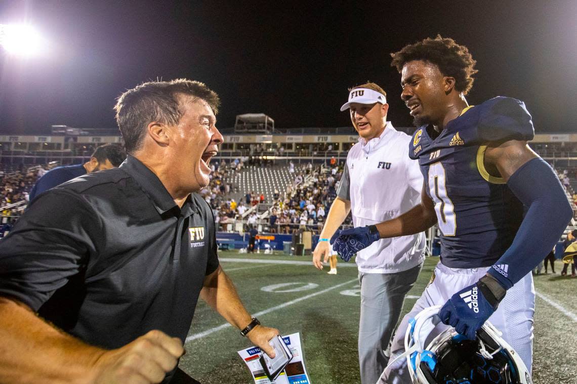 Florida International University Head Coach Mike MacIntyre reacts with wide receiver Tyrese Chambers (0) after defeating Bryant University 38-37 in overtime of an NCAA Conference USA football game at Riccardo Silva Stadium in Miami, Florida, on Thursday, September 1, 2022.