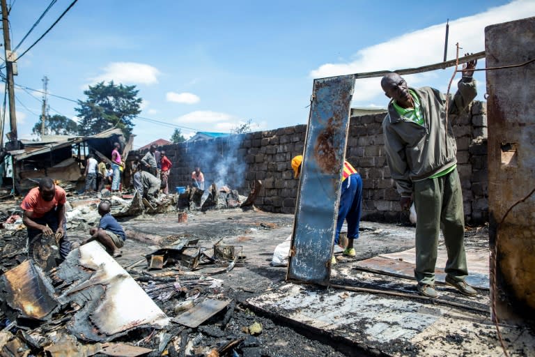 Residents of Nairobi's Kibera slum clean up a shop that was burned down during clashes after President Uhuru Kenyatta was declared the winner of last week's protest-hit election