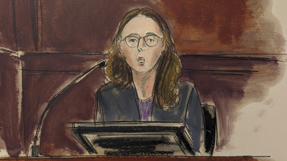 In this courtroom sketch, Caroline Ellison testifies in Manhattan federal court, Tuesday, Oct. 10, 2023, in New York. The former fellow top executive and ex-girlfriend of Sam Bankman-Fried, Ellison, began testifying against him, immediately blaming her former boyfriend for directing her to commit crimes before his cryptocurrency empire collapsed last November. (Elizabeth Williams via AP)