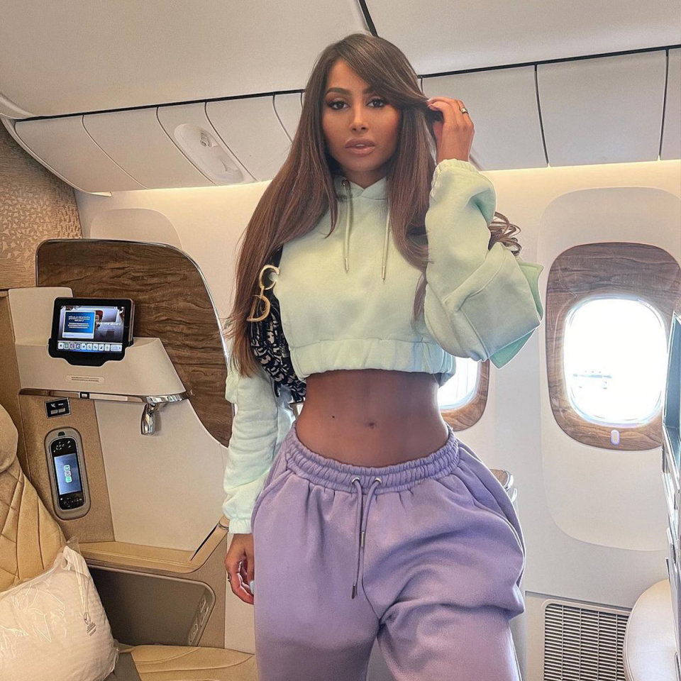 French Océane El Himer poses in front of a business class seat.