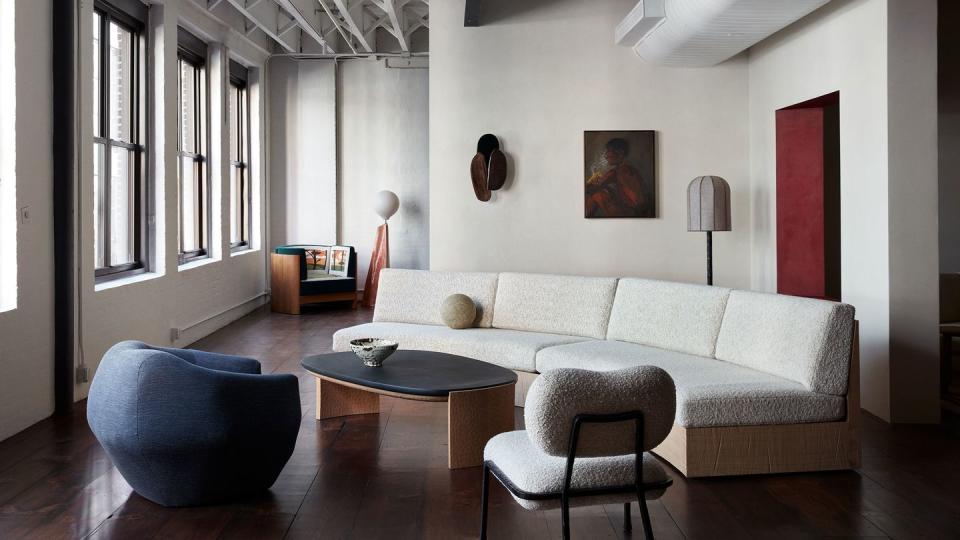 a living room with a couch and chairs