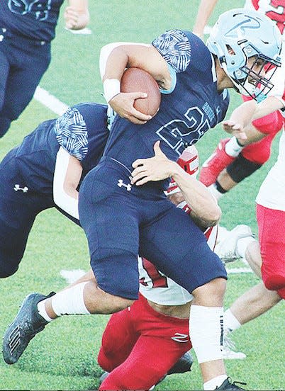 Bartlesville High School running back Caleb Perry breaks through resistance against Claremore High in the 2020 opener — the only game in which Perry would play his senior season. After three years away from football, Perry is revving up to play in 2023 for Mid-America Nazarene (Kan).