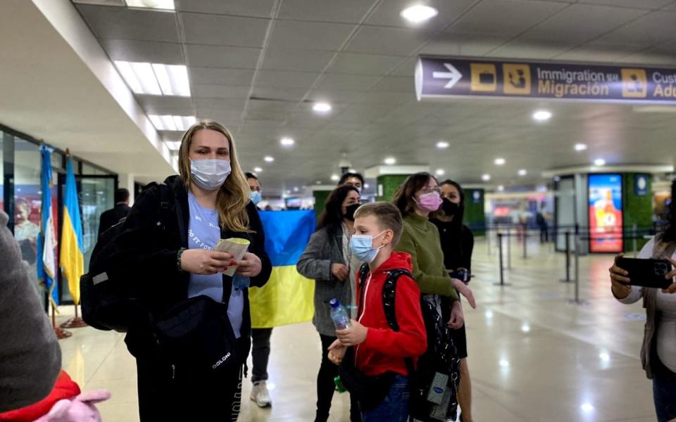 A Ukrainian family fleeing their homeland following Russia's invasion of Ukraine, arrive at La Aurora International airport in Guatemala City, Guatemala March 11, 2022. Guatemala Ministry of Foreign Relations/Handout via REUTERS THIS IMAGE HAS BEEN SUPPLIED BY A THIRD PARTY NO RESALES. NO ARCHIVES  - Guatemala Ministry of Foreign Relations /Reuters 