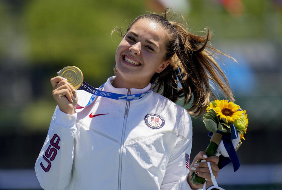 Nevin Harrison receives her Olympic gold medal after winning the 200-meter canoe sprint.