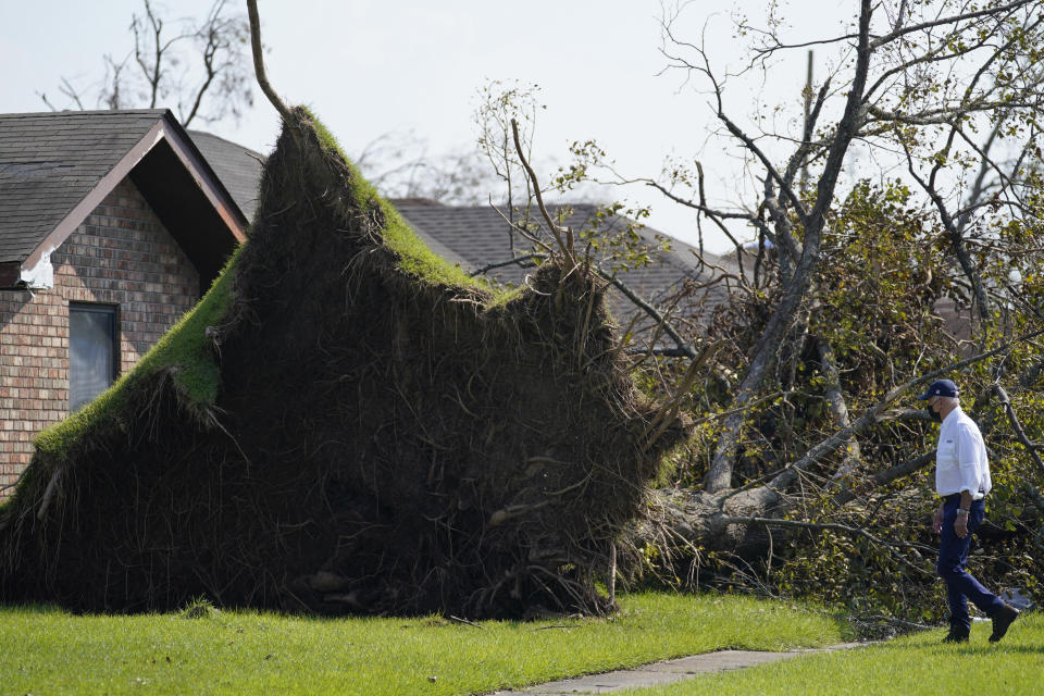 FILE - In this Sept. 3, 2021, file photo President Joe Biden tours a neighborhood impacted by Hurricane Ida in LaPlace, La. Surveying damage from California wildfires to hurricane-induced flooding in Louisiana and New York Biden said America must get serious about the “code red” danger posed by global warming. (AP Photo/Evan Vucci, File)