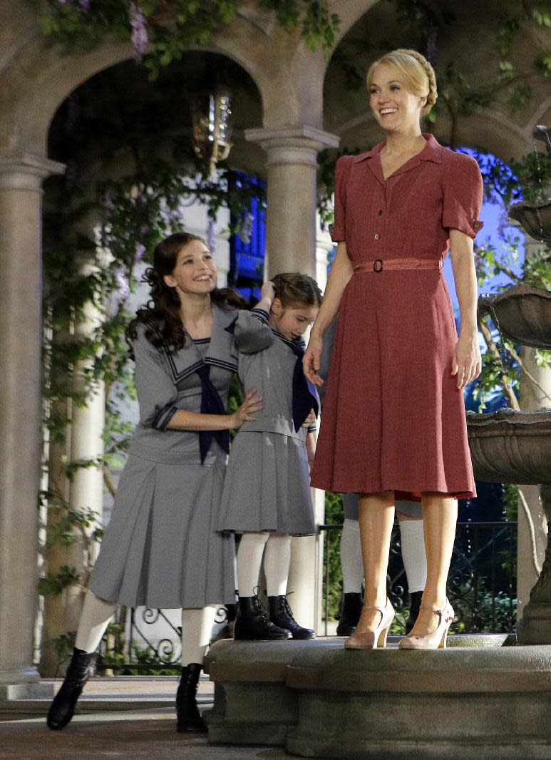 This image released by NBC shows Carrie Underwood, right, as Maria, and fellow cast members Ariane Rinehart as Liesl, left, and Peyton Ella as Gretl, during preparations for "The Sound of Music Live!, in Bethpage, N.Y. The live production airs on Dec. 5 at 8 p.m. EST. (AP Photo/NBC, Paul Drinkwater)