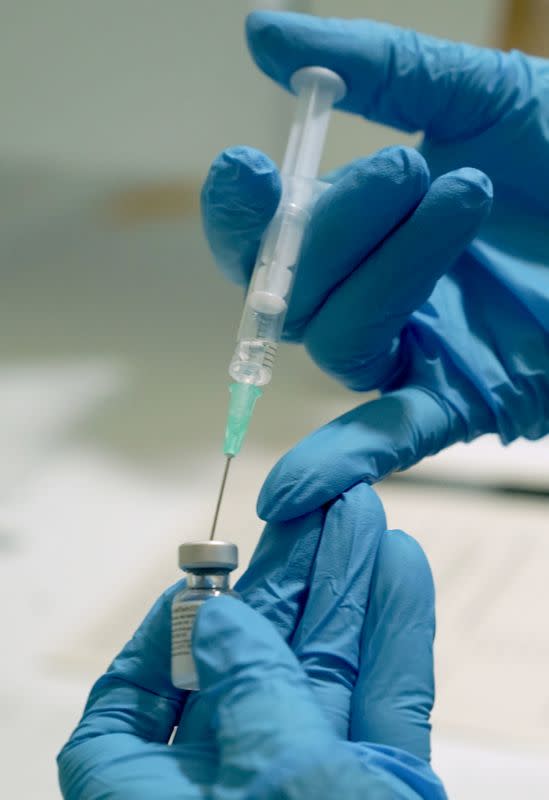 FILE PHOTO: A needle is filled from a phial of Pfizer/BioNTech COVID-19 vaccine at the Royal Victoria Infirmary in Newcastle