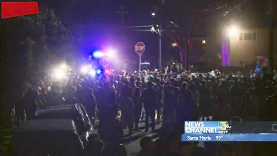 This video image provided by KEYT-TV shows a crowd confronting police at a disturbance Saturday April 5, 2014, during a weekend college party in Southern California that devolved into a street brawl. About 100 people were arrested and at least 44 people were taken to the hospital. (AP Photo/KEYT-TV)