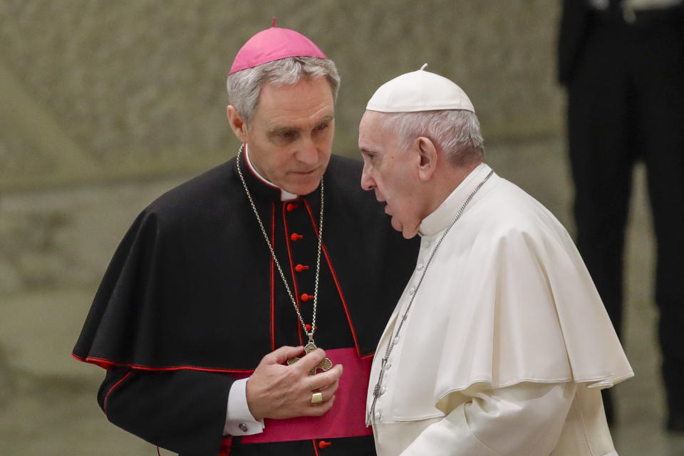 FILE - Pope Francis talks with Papal Household Archbishop Georg Gaenswein during his weekly general audience, in the Paul VI Hall at the Vatican on Jan. 15, 2020. Pope Francis has exposed the political “maneuvers” to sway votes during the past two conclaves and denied he is planning to reform the process to elect a pope in a new book-length interview published Tuesday April 2, 2024. (AP Photo/Alessandra Tarantino, file )