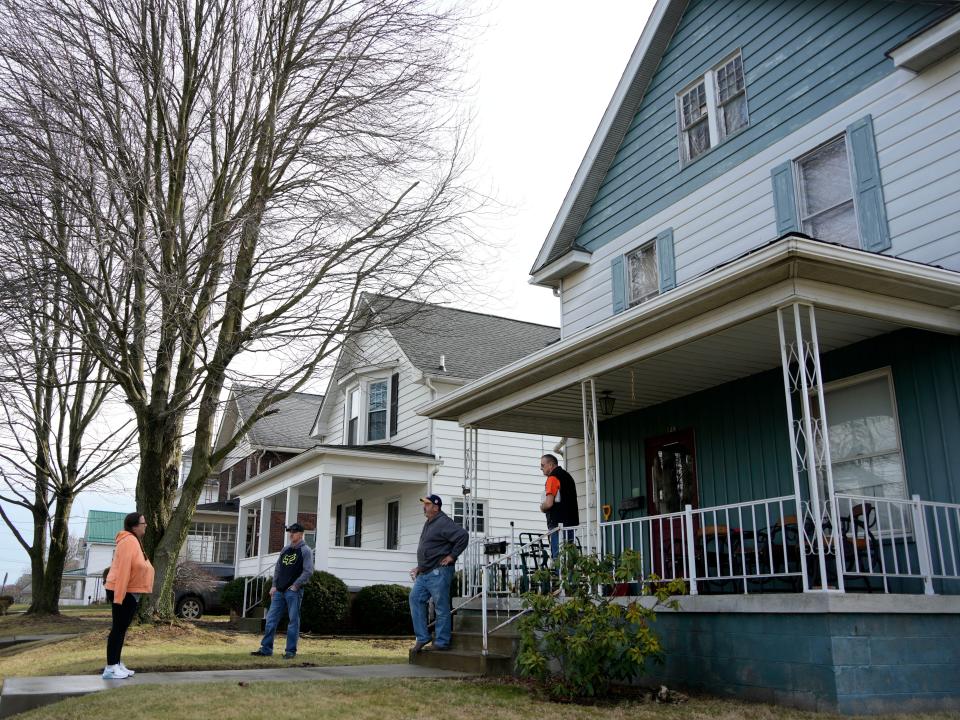 Neighbors gather outside a house in East Palestine on February 9.