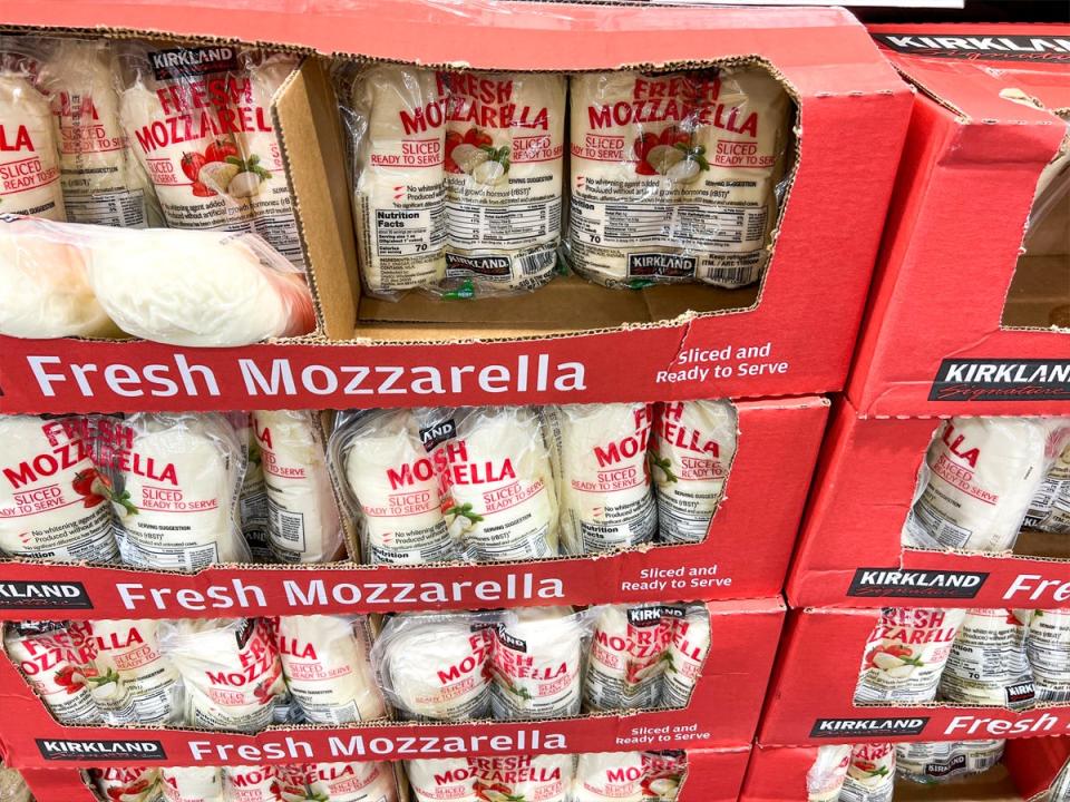 Clear packages of mozzarella inside of cardboard boxes on display at Costco