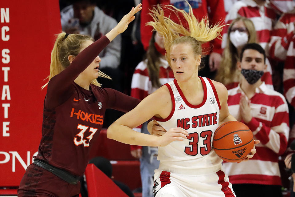 Virginia Tech's Elizabeth Kitle , left, battles with North Carolina State's Elissa Cunane, right, during the first half of an NCAA college basketball game, Sunday, Jan. 23, 2022, in Raleigh, N.C. (AP Photo/Karl B. DeBlaker)