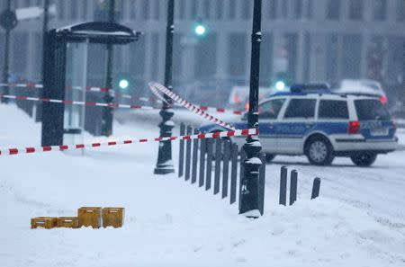 A police car is parked behind suspicious yellow postal crates near the chancellory in Berlin, Germany on January 6, 2016. REUTERS/Hannibal Hanschke