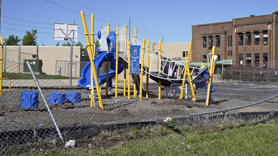 This Friday, Sept. 4, 2020 photo shows flowers placed as a memorial at a playground where a car driven by a slain Cleveland police detective came to rest after being shot the night before in Cleveland. Three people have been arrested in the shooting that killed Detective James Skernivitz, 53, said Jeff Follmer, president of the Cleveland Police Patrolmen's Association, the department's largest police union. (AP Photo/Tony Dejak)