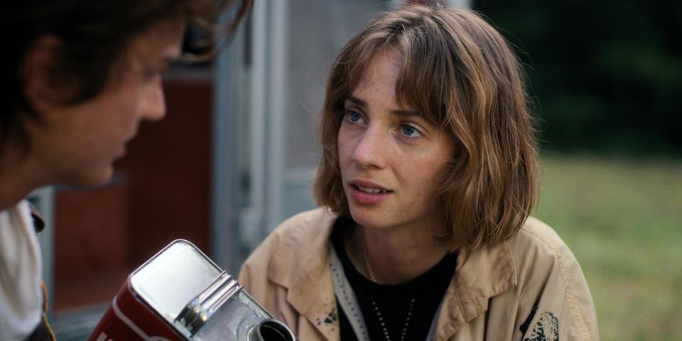 closeup of her character listening intently to a teen outside