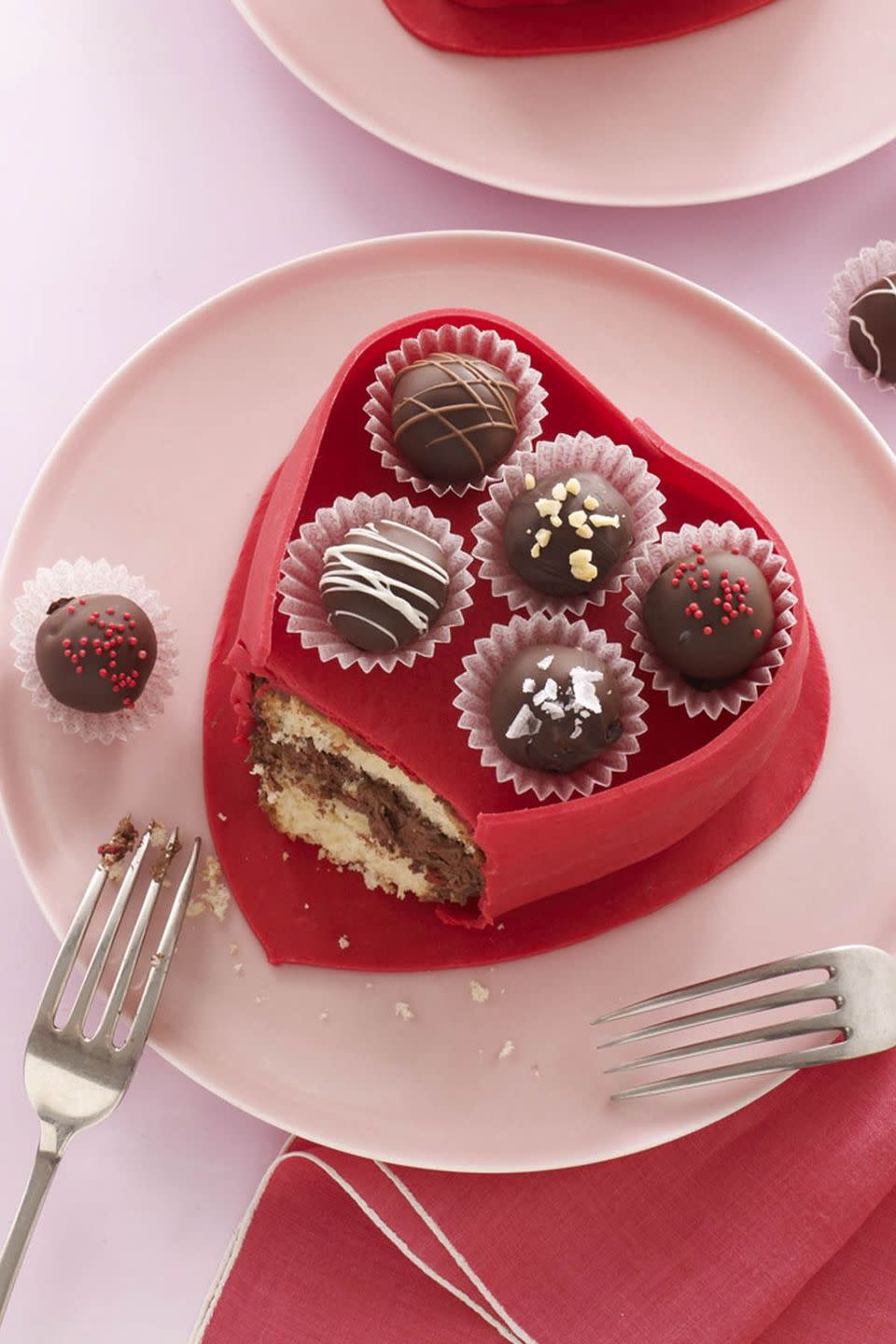 <p>Top this buttery cake with rich chocolate truffles for maximum sweetness. </p><p><a href="https://www.womansday.com/food-recipes/food-drinks/recipes/a11637/truffle-box-cake-recipe-wdy0213/" rel="nofollow noopener" target="_blank" data-ylk="slk:Get the Truffle Box Cake recipe.;elm:context_link;itc:0;sec:content-canvas" class="link "><em>Get the Truffle Box Cake recipe.</em></a></p>