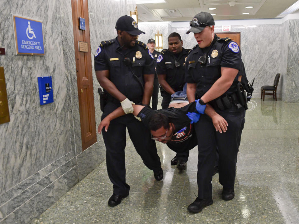 <p>A protester is detained and carried out by U.S. Capitol Police as they attempt to maintain order in the hallways outside the Senate Finance Committee hearing on the last-ditch GOP push to overhaul the nation’s health care system, on Capitol Hill in Washington, Monday, Sept. 25, 2017. (AP Photo/Susan Walsh) </p>