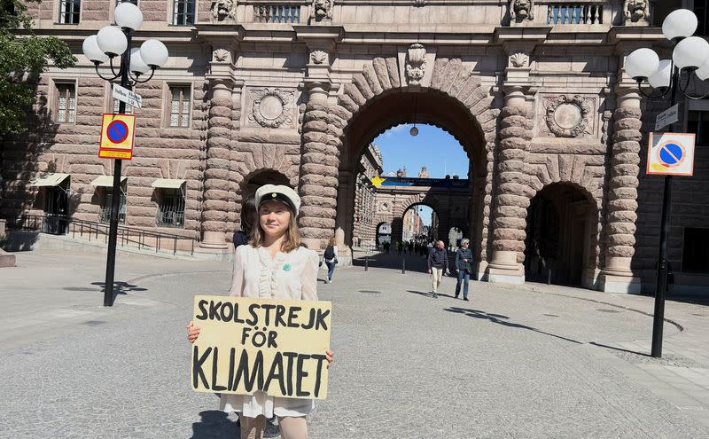 Greta Thunberg stands outside the Swedish Parliament in Stockholm