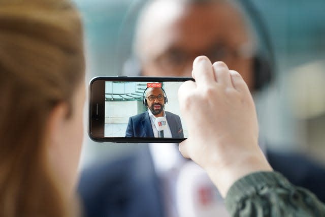 Home Secretary James Cleverly speaking to the media