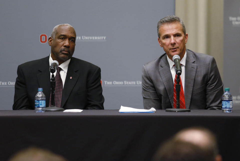 Ohio State football coach Urban Meyer, right, answers questions as athletic director Gene Smith listens during a news conference in Columbus, Ohio, Wednesday, Aug. 22, 2018. (AP Photo/Paul Vernon)