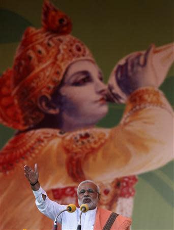 Hindu nationalist Narendra Modi, prime ministerial candidate for India's main opposition Bharatiya Janata Party (BJP), addresses a rally in front of an image of Hindu god Krishna in the northern Indian city of Agra November 21, 2013. REUTERS/Anindito Mukherjee