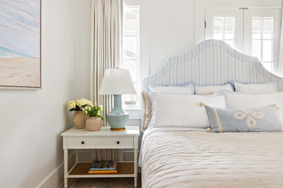 a bedroom on the second floor of the beach house