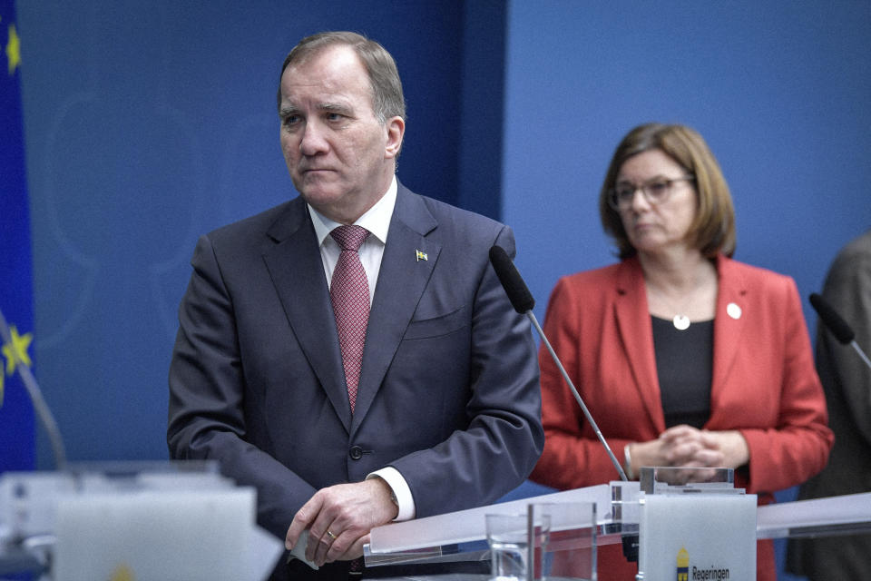 Sweden's Prime Minister Stefan Lofven and Deputy Prime Minister Isabella Lovin hold a coronavirus news conference, in Stockholm, Friday, Dec. 18,2020. The Swedish government is tightening nationwide coronavirus restrictions by lowering the number of people who can gather in a restaurant and making face masks mandatory on public transportation. Sweden has stood out among European nations for its comparatively hands-off response to the pandemic. (Jessica Gow/TT News Agency via AP)