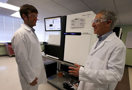 Alan Shuldiner (R) and Aris Baras, co-heads of the Regeneron Genetics Center, stand near genetic sequencing machines at a Regeneron Pharmaceuticals Inc. laboratory at the biotechnology company's headquarters in Tarrytown, New York March 24, 2015. REUTERS/Mike Segar