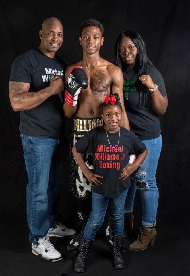 Michael Williams Jr., center, with his family: His parents Michael Williams Sr. and Tihesia Williams, and his sister, Amirah. Michael Williams Jr., who is undefeated as a professional boxer, is scheduled to box at Madison Square Garden in a match to be broadcast on ESPN+ on Saturday, Dec. 11, 2021.