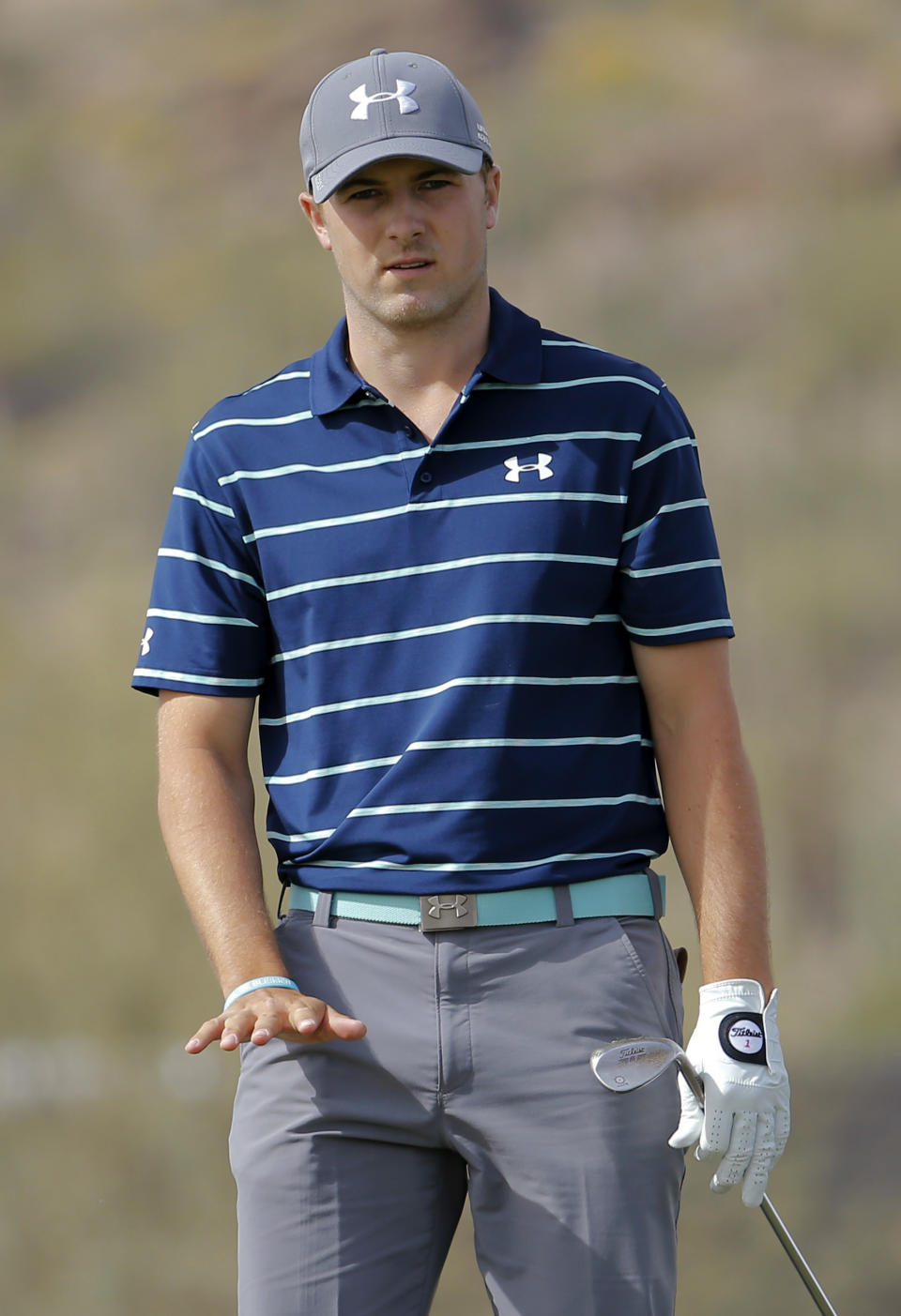 Jordan Spieth watches his chip shot on the eighth hole in his match against Matt Kuchar during the third round of the Match Play Championship golf tournament, Friday, Feb. 21, 2014, in Marana, Ariz. (AP Photo/Matt York)