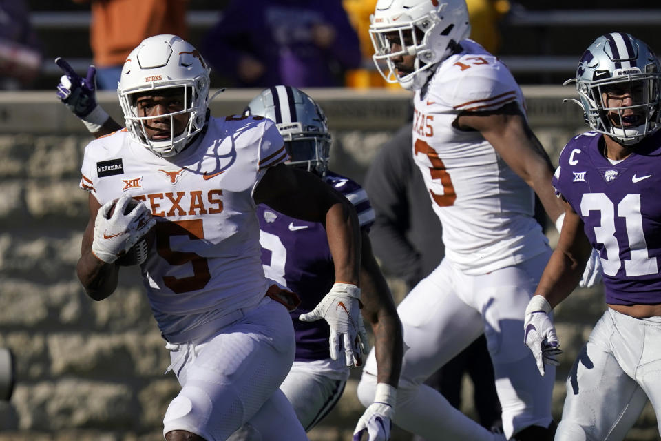 Texas running back Bijan Robinson (5) breaks free for a touchdown during the first half of an NCAA college football game against Kansas State in Manhattan, Kan., Saturday, Dec. 5, 2020. Robinson scored three touchdowns in the game. Texas defeated Kansas State 69-31. (AP Photo/Orlin Wagner)