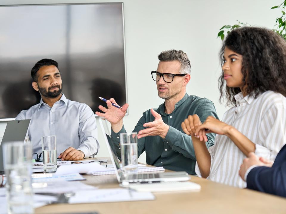 people sitting at table during business meeting