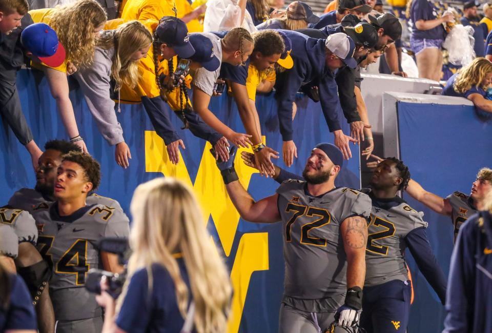 Sep 9, 2023; Morgantown, West Virginia, USA; West Virginia Mountaineers offensive lineman Doug Nester (72) celebrates with fans after defeating the Duquesne Dukes at Mountaineer Field at Milan Puskar Stadium. Mandatory Credit: Ben Queen-USA TODAY Sports