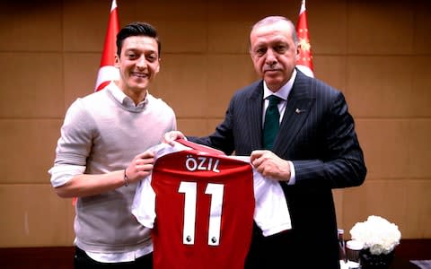 Footballer Mesut Özil posing with Recep Tayyip Erdogan, the Turkish president - Credit: KAYHAN OZER/AFP