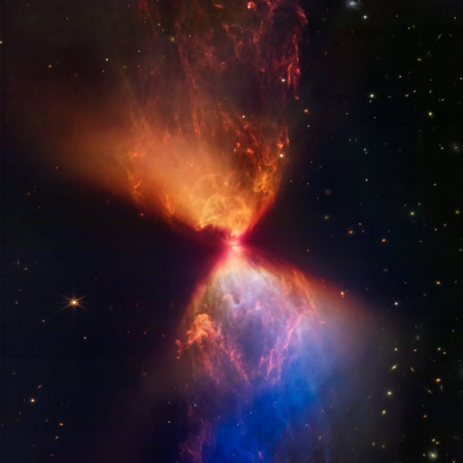 An image of a protostar from the James Webb Space Telescope with an orange cloud meeting a pink cloud