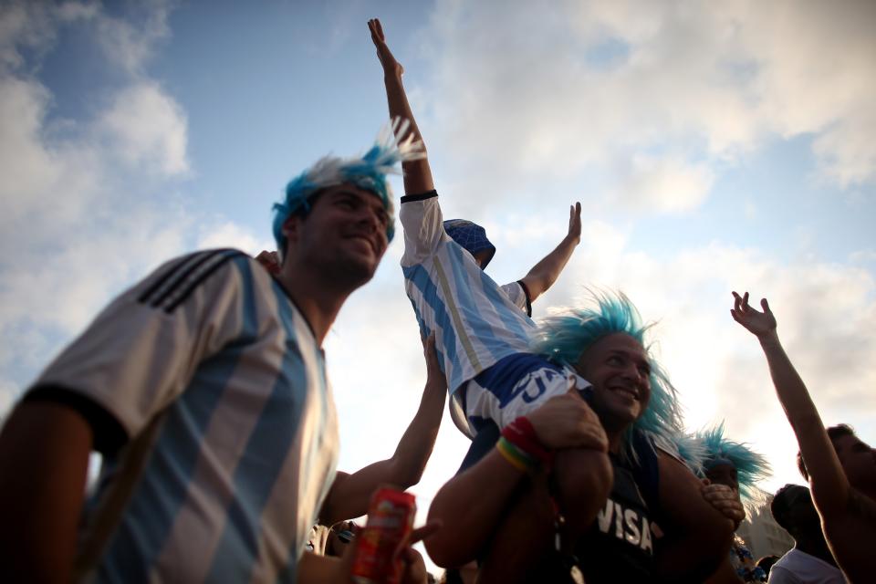 RIO DE JANEIRO, BRAZIL - JUNE 21: Argentine team fans react to their team beating the Iran team as they watch on the screen setup at the Word Cup FIFA Fan Fest during on Copacabana beach June 21, 2014 in Rio de Janeiro, Brazil. Argentina won the match 1-0. (Photo by Joe Raedle/Getty Images)