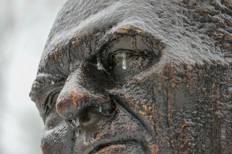 Ice forms on the statue of William Oxley Thompson outside the library on Ohio State's campus on Thursday, Feb. 3, 2022. Winter weather and poor road conditions closed the university and all activities on Thursday.