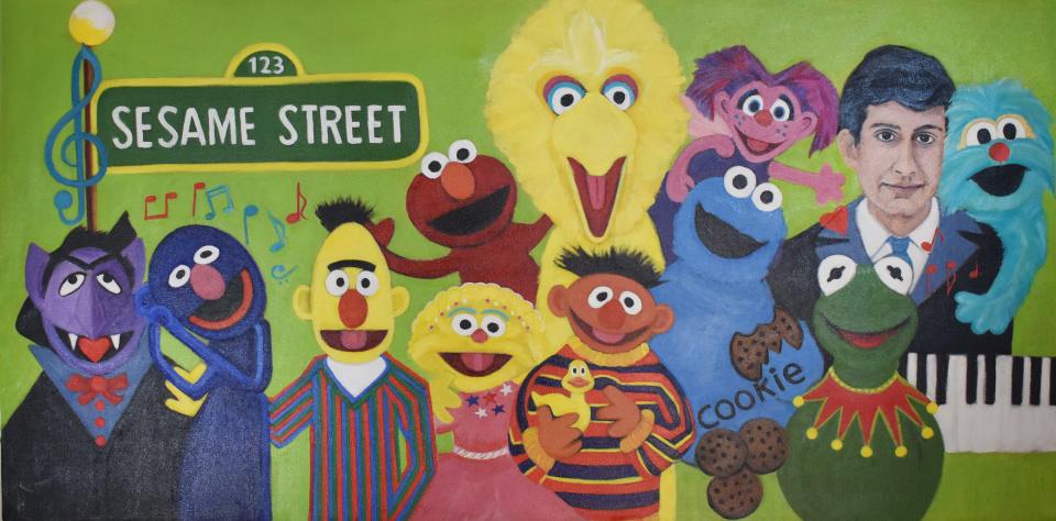Sheila Oliveira's portrait of Joe Raposo features the beloved composer with some of his friends from Sesame Street.