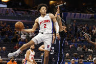 Detroit Pistons guard Cade Cunningham (2) passes the ball around Orlando Magic guard Cole Anthony during the first half of an NBA basketball game Friday, Jan. 28, 2022, in Orlando, Fla. (AP Photo/Scott Audette)