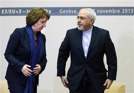 European Union foreign policy chief Catherine Ashton (L) gets up with Iranian Foreign Minister Mohammad Javad Zarif after a photo opportunity before the start of three days of closed-door nuclear talks at the United Nations European headquarters in Geneva November 20, 2013. REUTERS/Denis Balibouse