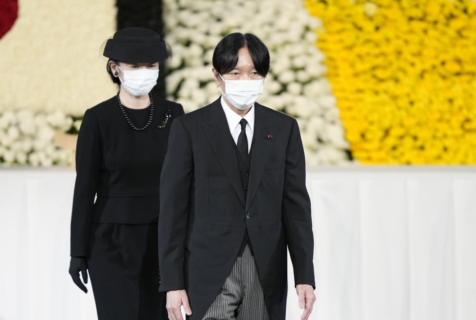 Japan's Crown Prince Akishino, right, and Crown Princess Kiko walks on stage after paying their respects during the state funeral of former Japanese Prime Minister Shinzo Abe at the Nippon Budokan, Tuesday, Sept. 27, 2022, in Tokyo. (Franck Robichon/Pool Photo via AP)