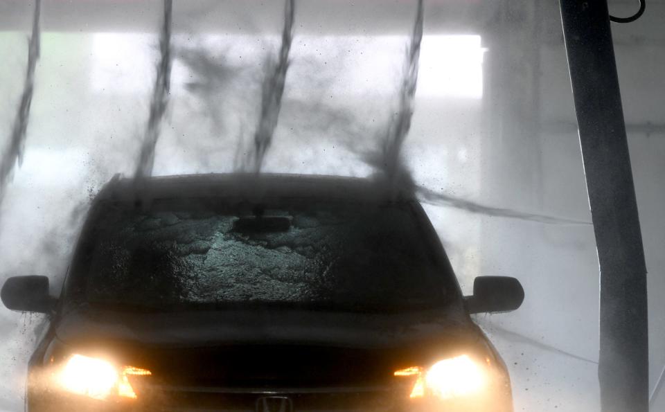 Robin McIntyre of Minerva takes her car through the car wash at Roy's Car Wash and Lube in Alliance. More car washes are opening because of increased demand, experts say.