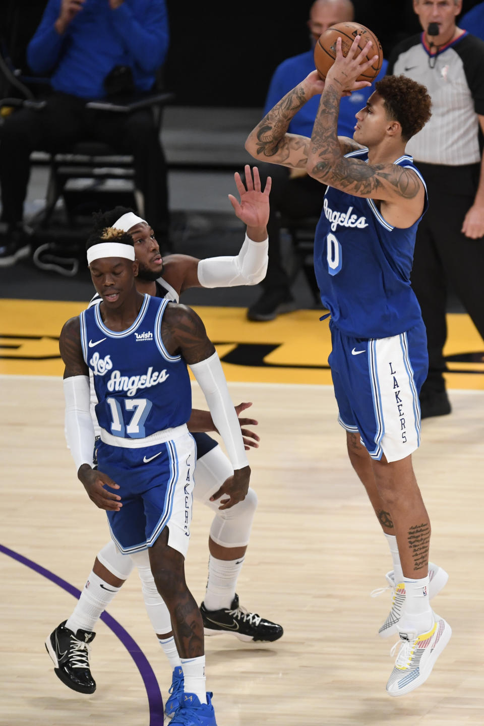 Los Angeles Lakers forward Kyle Kuzma, right, shoots a 3-point basket during the first half of an NBA basketball game against the Minnesota Timberwolves in Los Angeles, Sunday, Dec. 27, 2020. (AP Photo/Kyusung Gong)