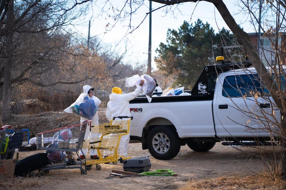 City workers cleared a camp in Edmonton's river valley Tuesday as the city continues to face legal action over how it approaches encampment removals. 