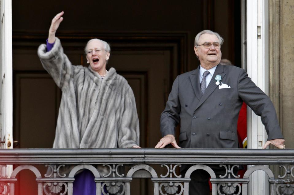 FILE - In this Jan. 15, 2012 file photo, Queen Margrethe, left, waves to supporters beside her husband Prince Henrik as the royal family appeared on balconies at Amalienborg Palace in Copenhagen. Spain's Crown Princess Letizia has a penchant for haute couture. Queen Elizabeth II's Bentley's are spotless. Belgium's King Albert II maintains a sumptuous villa in the south of France. But believe it or not, many of Europe's royals are feeling a pinch of the austerity sweeping the continent as it deals with its debt crisis. (AP Photo/Polfoto, Jens Dresling, File) DENMARK OUT