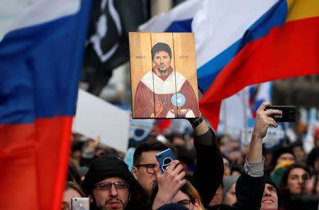 A man holds a picture of Pavel Durov, the founder of Telegram Messenger, during a rally to protest against tightening state control over internet in Moscow, Russia March 10, 2019. REUTERS/Shamil Zhumatov